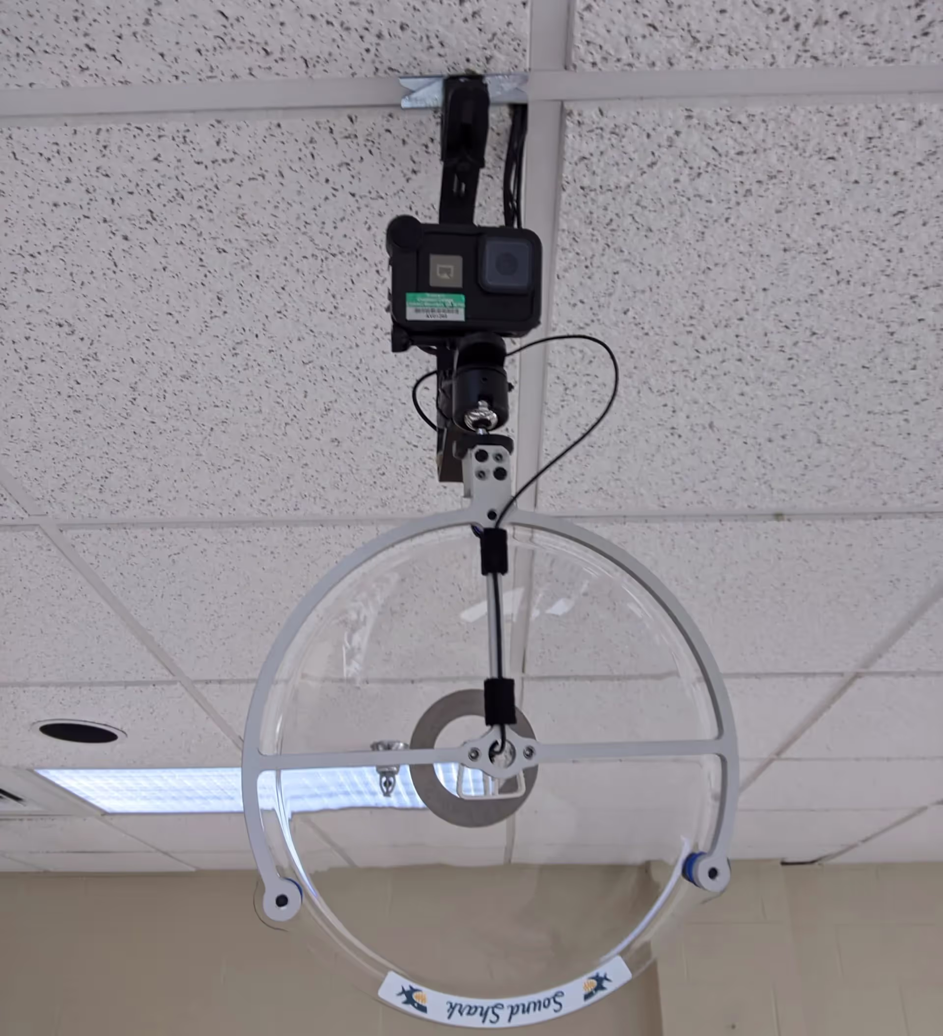 a Sound Shark with a GoPro camera suspended from a classroom ceiling
