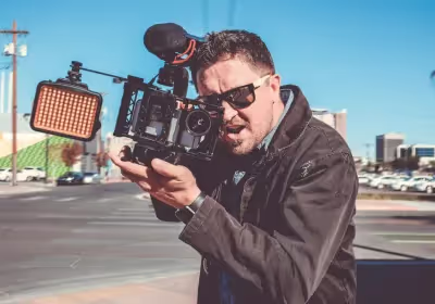 a man holding a video camera