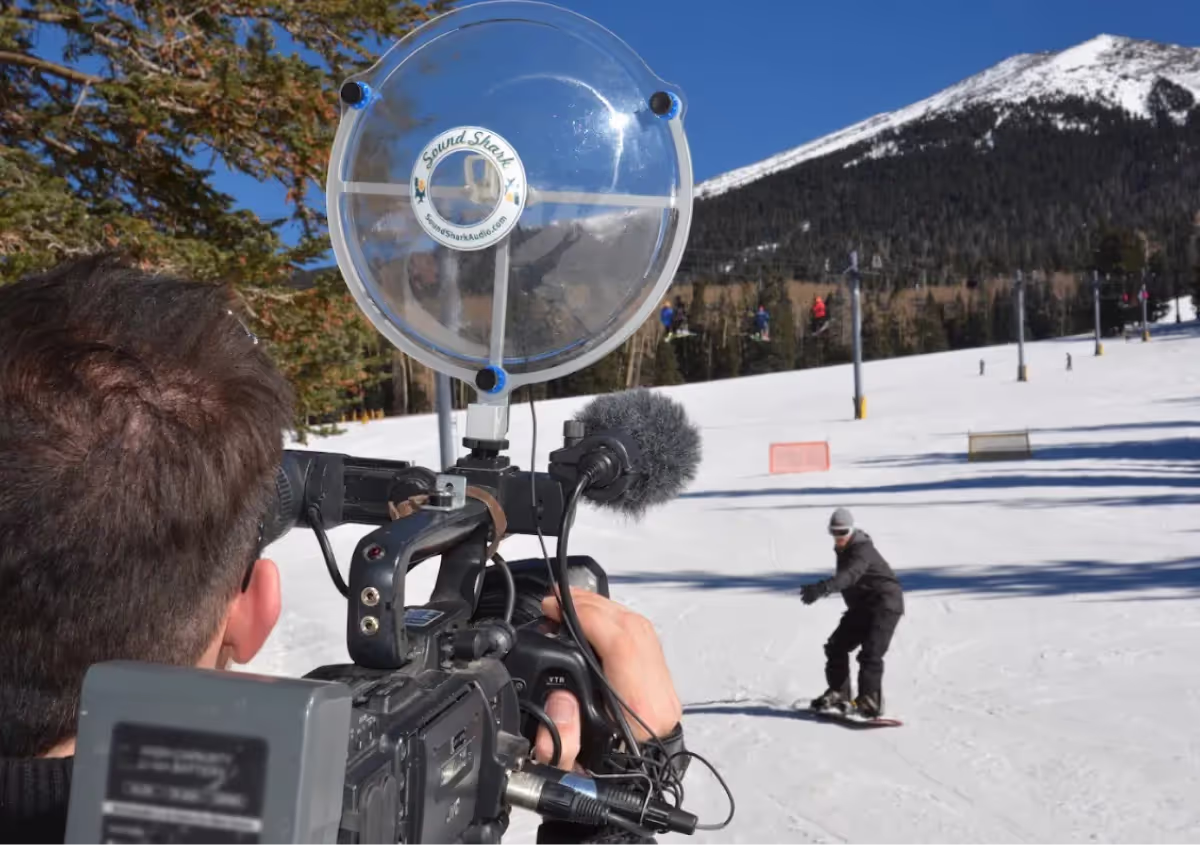 a Sound Shark long-range microphone being used on a video camera to record a snowboarder
