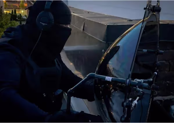 A security officer holding a KLOVER MiK 26 Stealth parabolic microphone